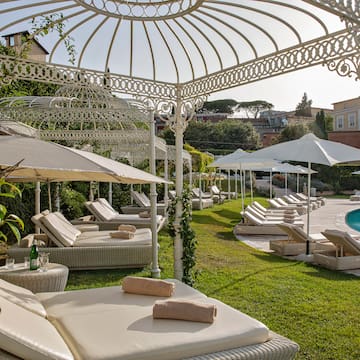 a pool with lounge chairs and umbrellas