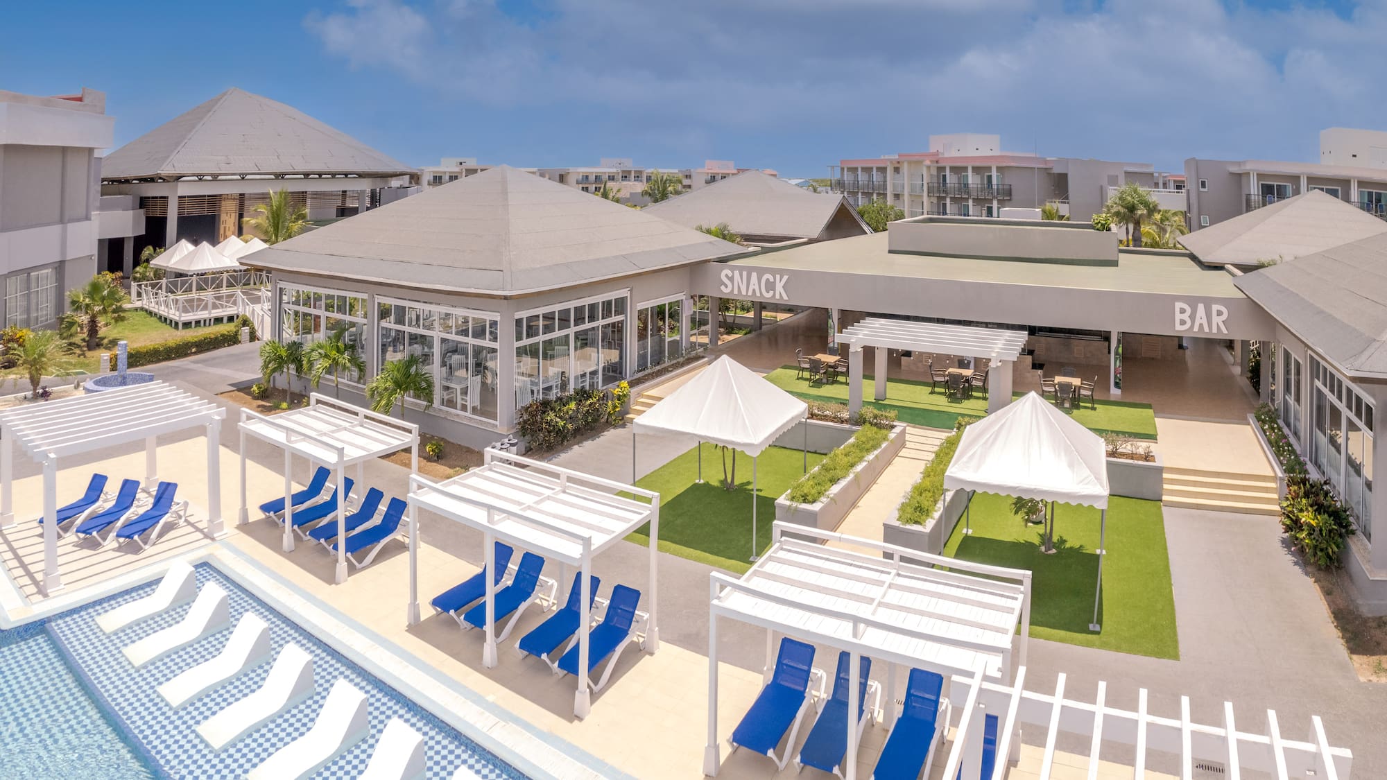 a pool with lounge chairs and a building with a pool