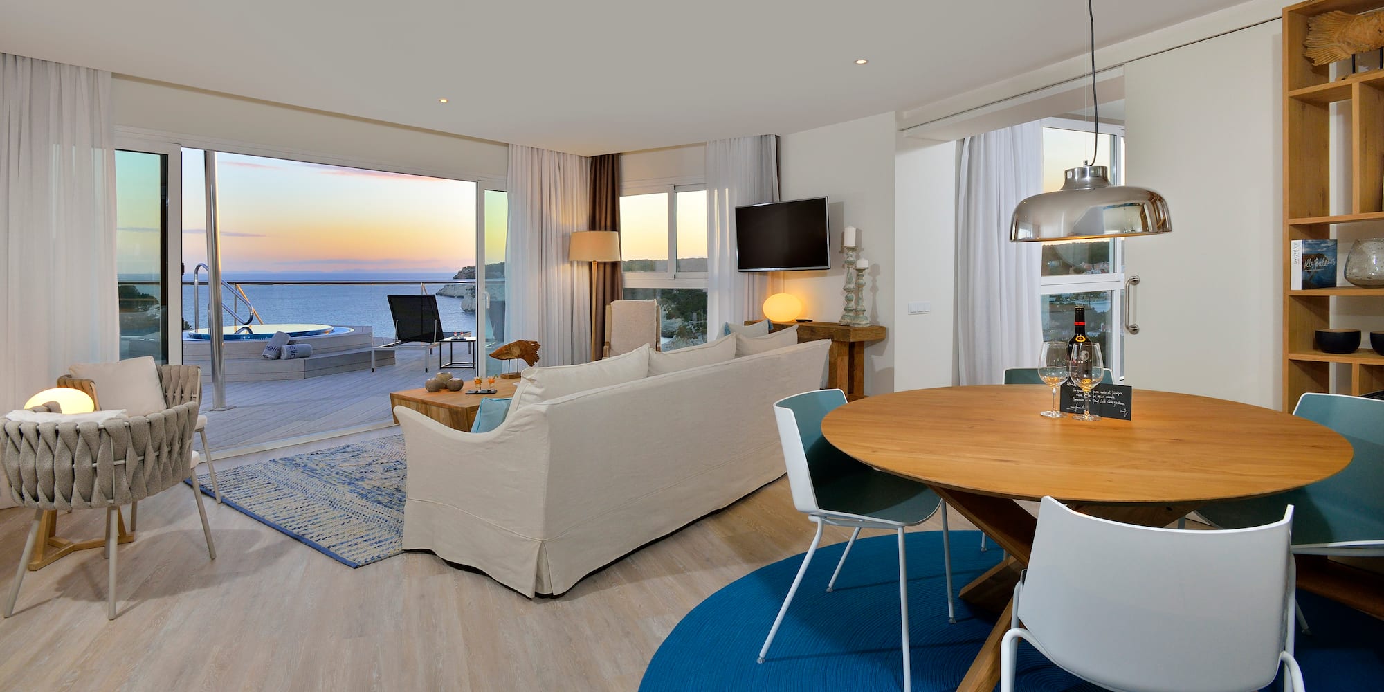 a living room with a table and chairs