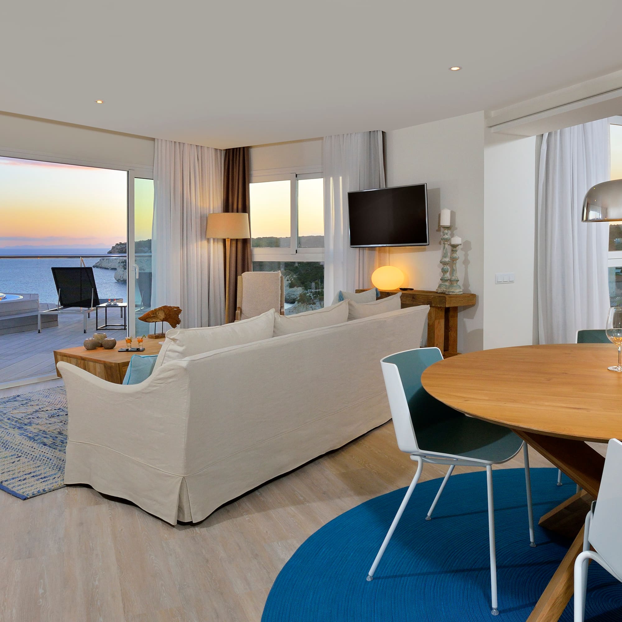 a living room with a table and chairs