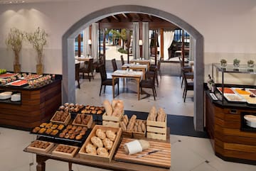 a room with a table of food and chairs