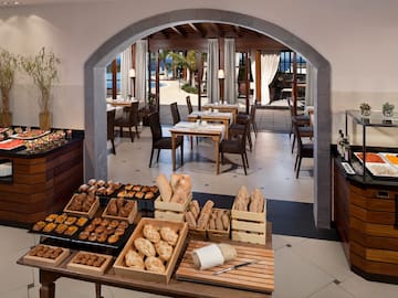 a room with a table of food and chairs