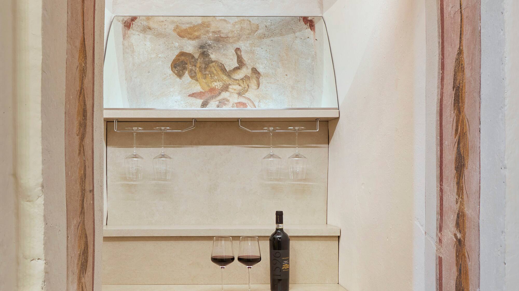 a wine bottle and glasses in a room