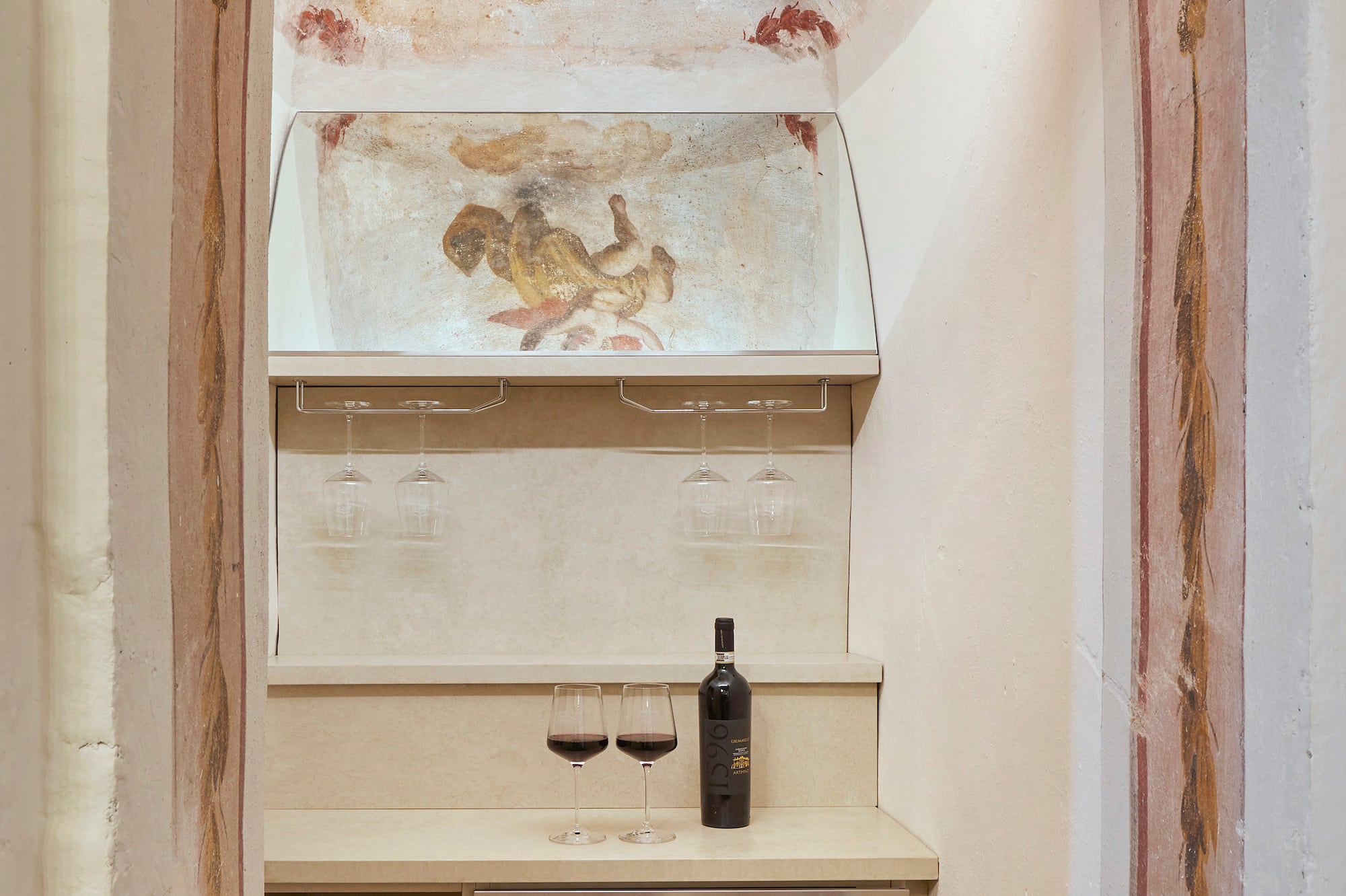 a wine bottle and glasses in a room