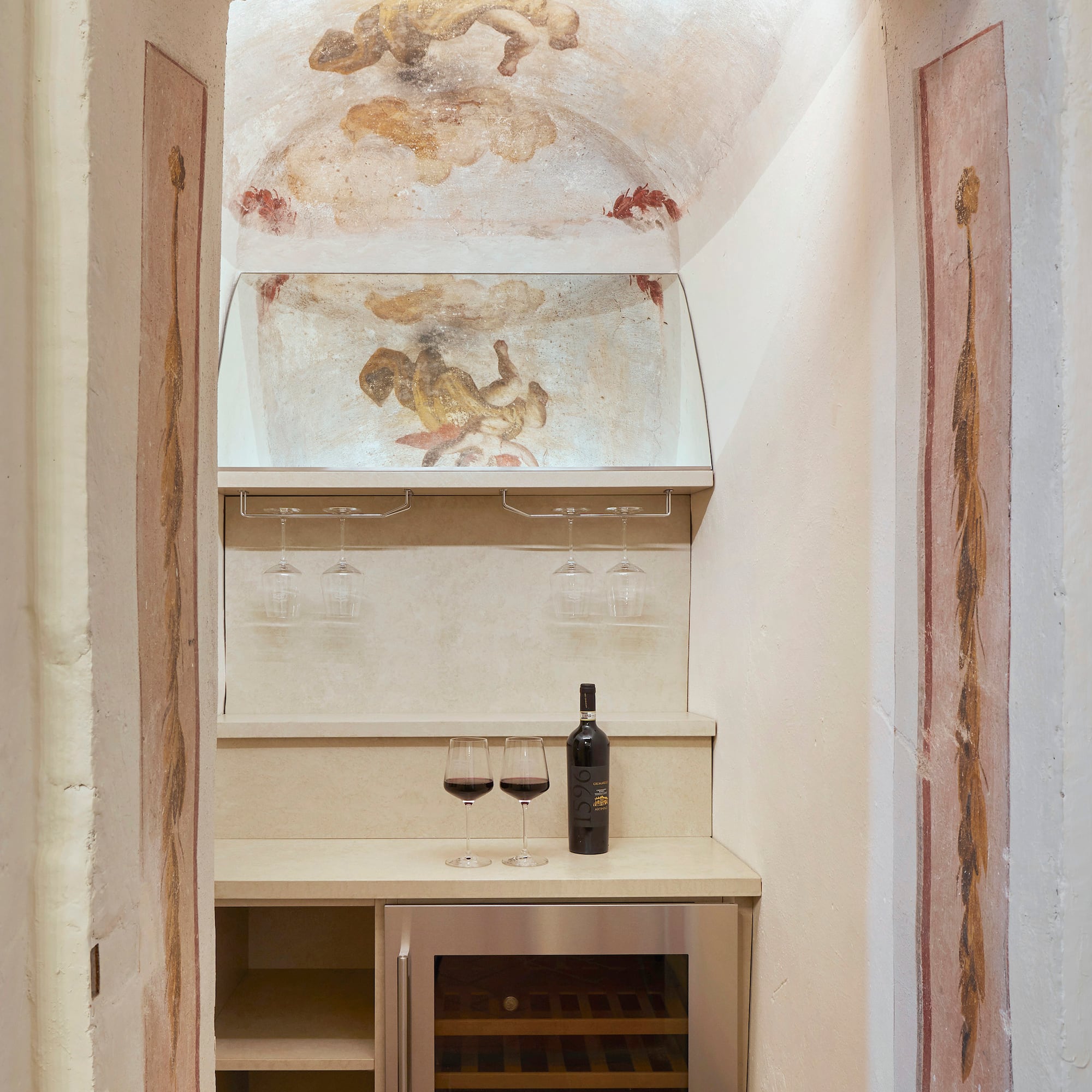 a wine bottle and glasses in a room