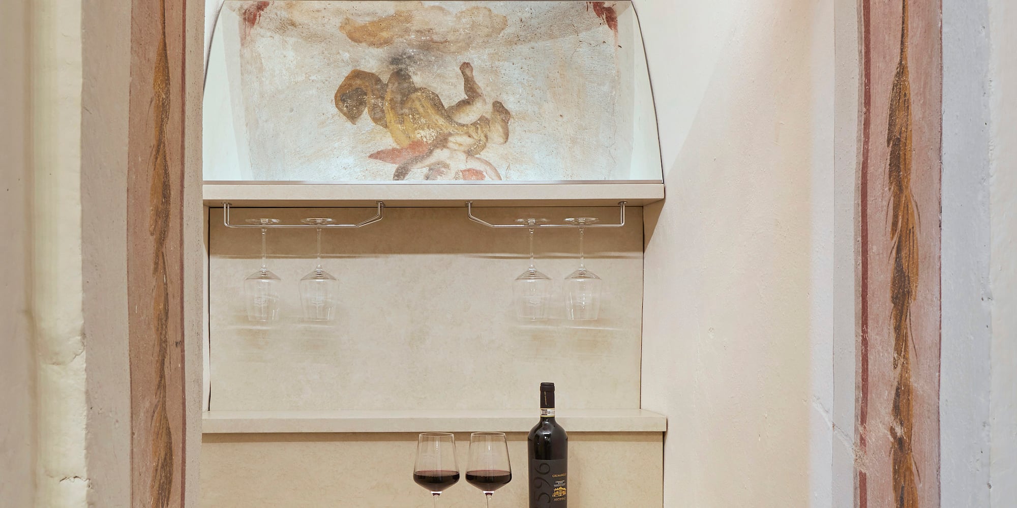 a wine bottle and glasses in a room