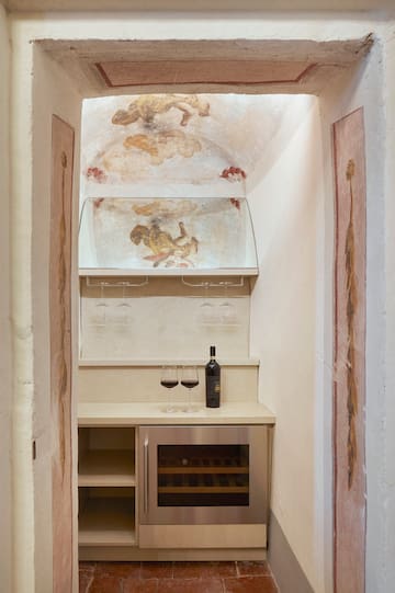 a wine bottle and glasses in a room