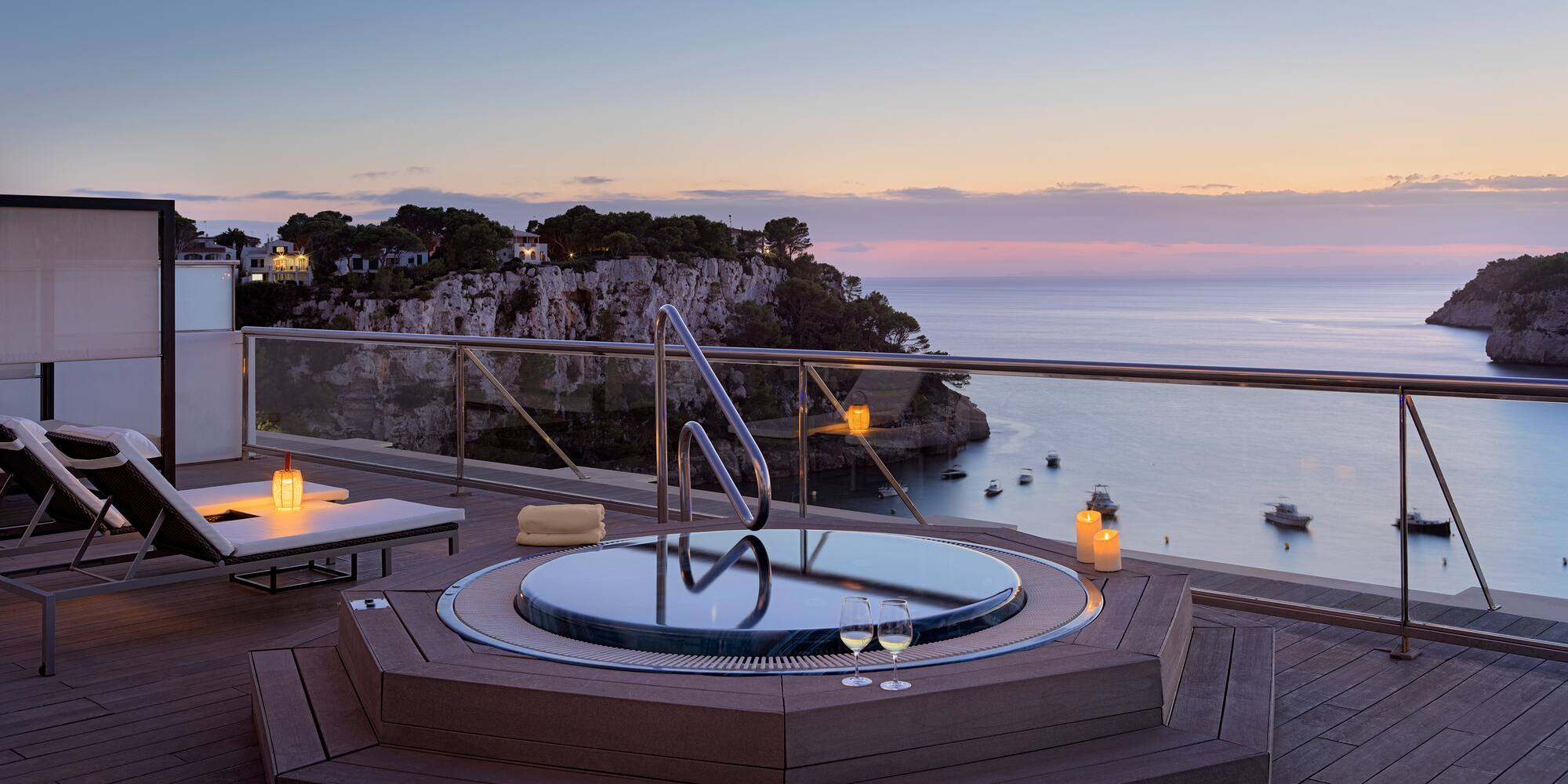 a hot tub on a deck overlooking a body of water