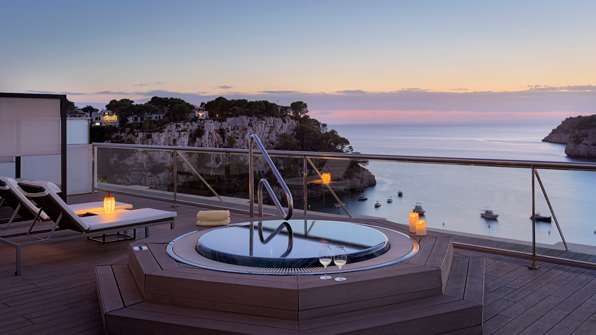 a hot tub on a deck overlooking a body of water
