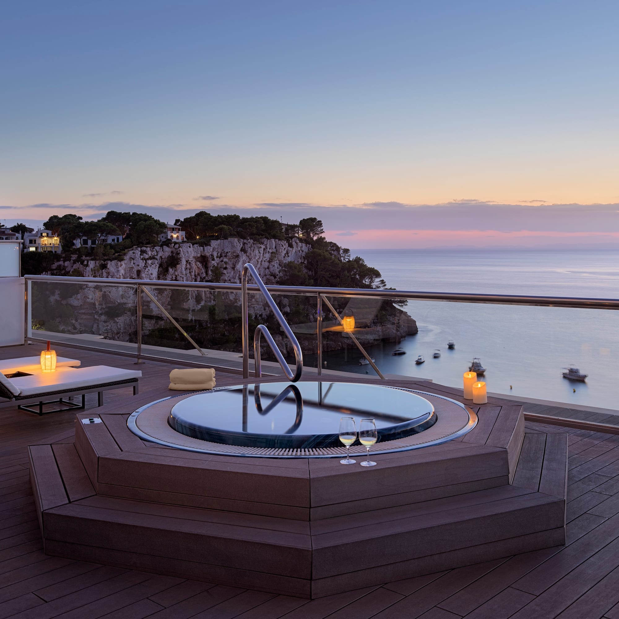 a hot tub on a deck overlooking a body of water