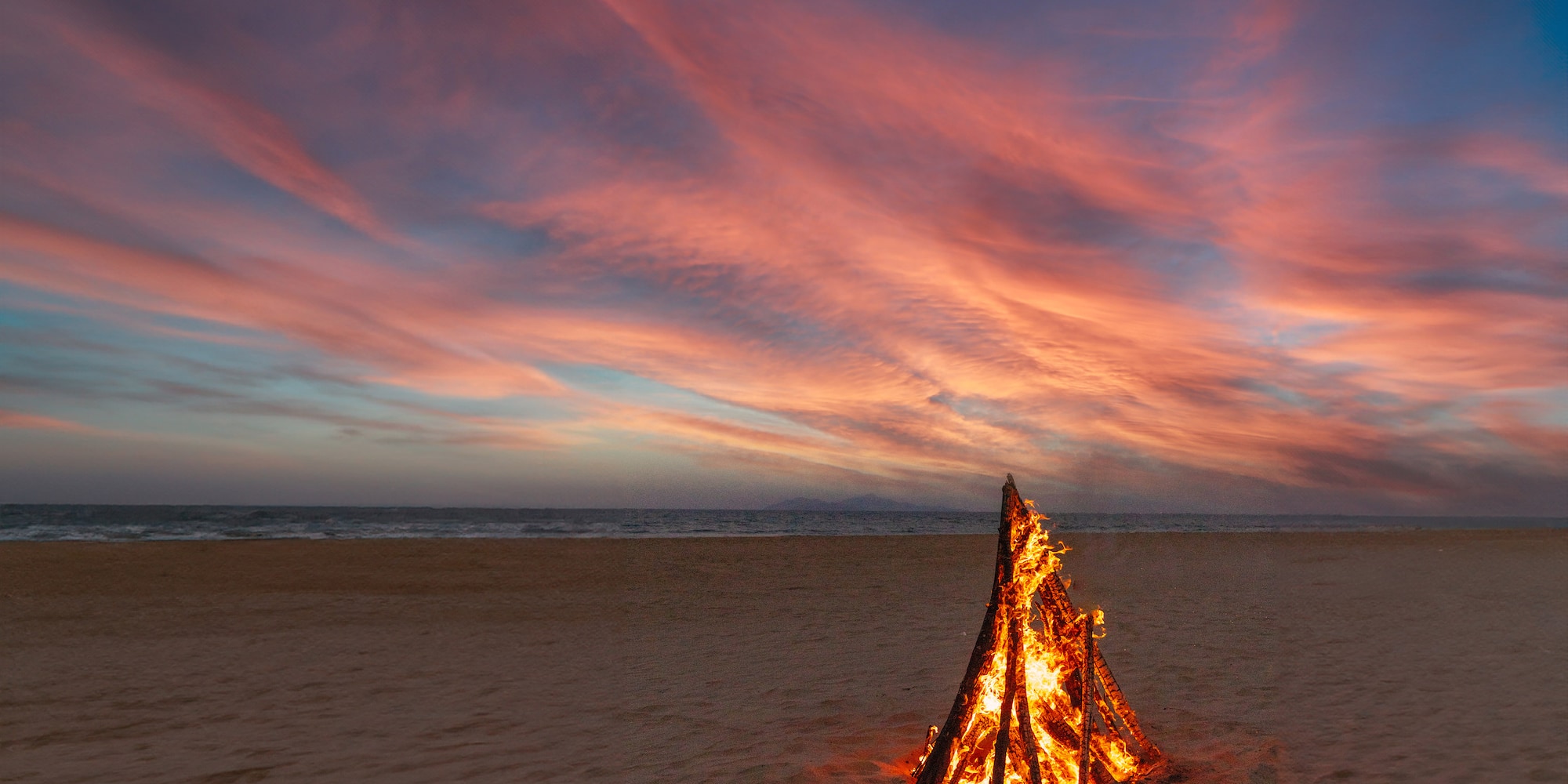 a bonfire on a beach