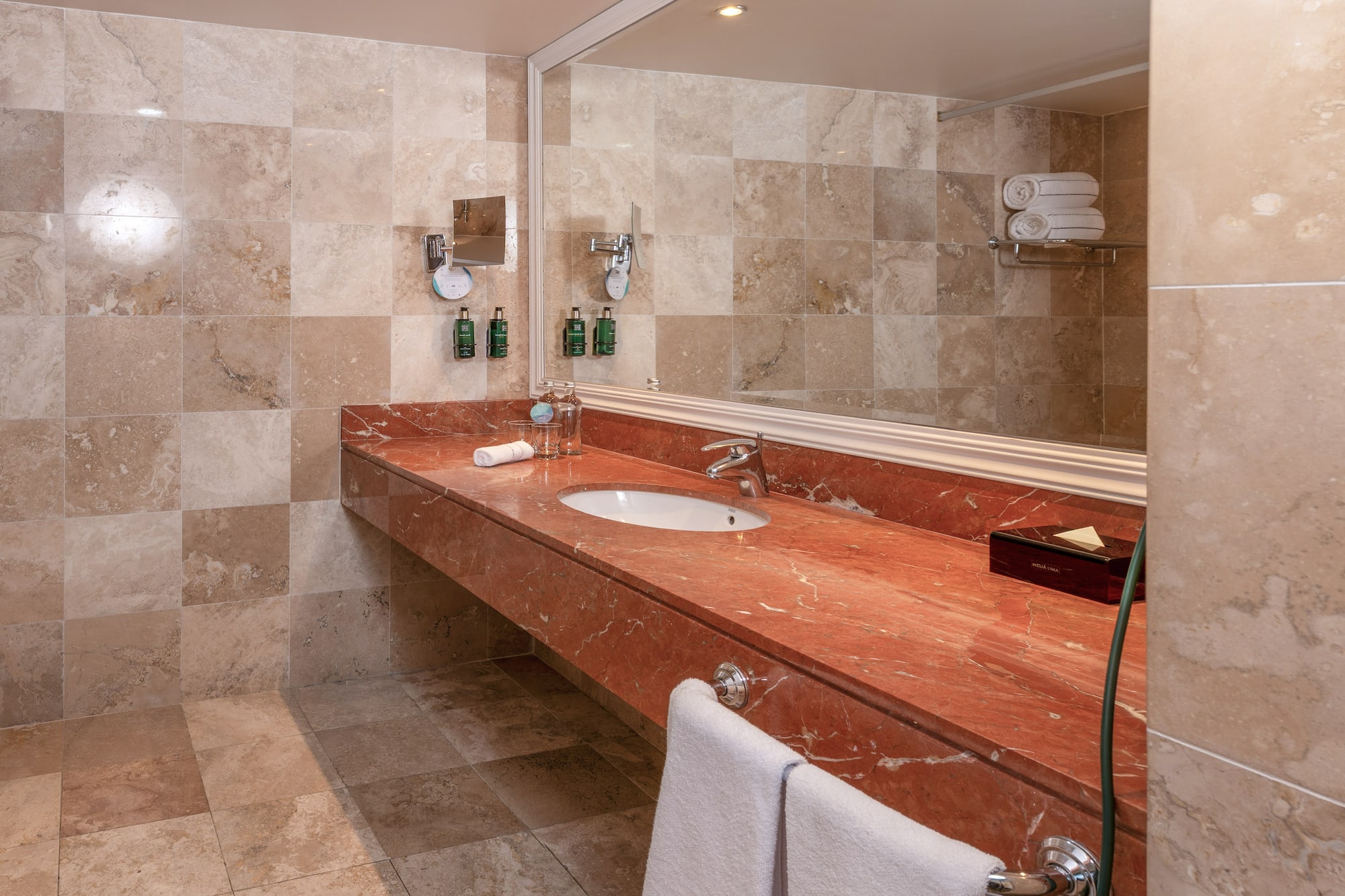 a bathroom with a marble countertop and a mirror