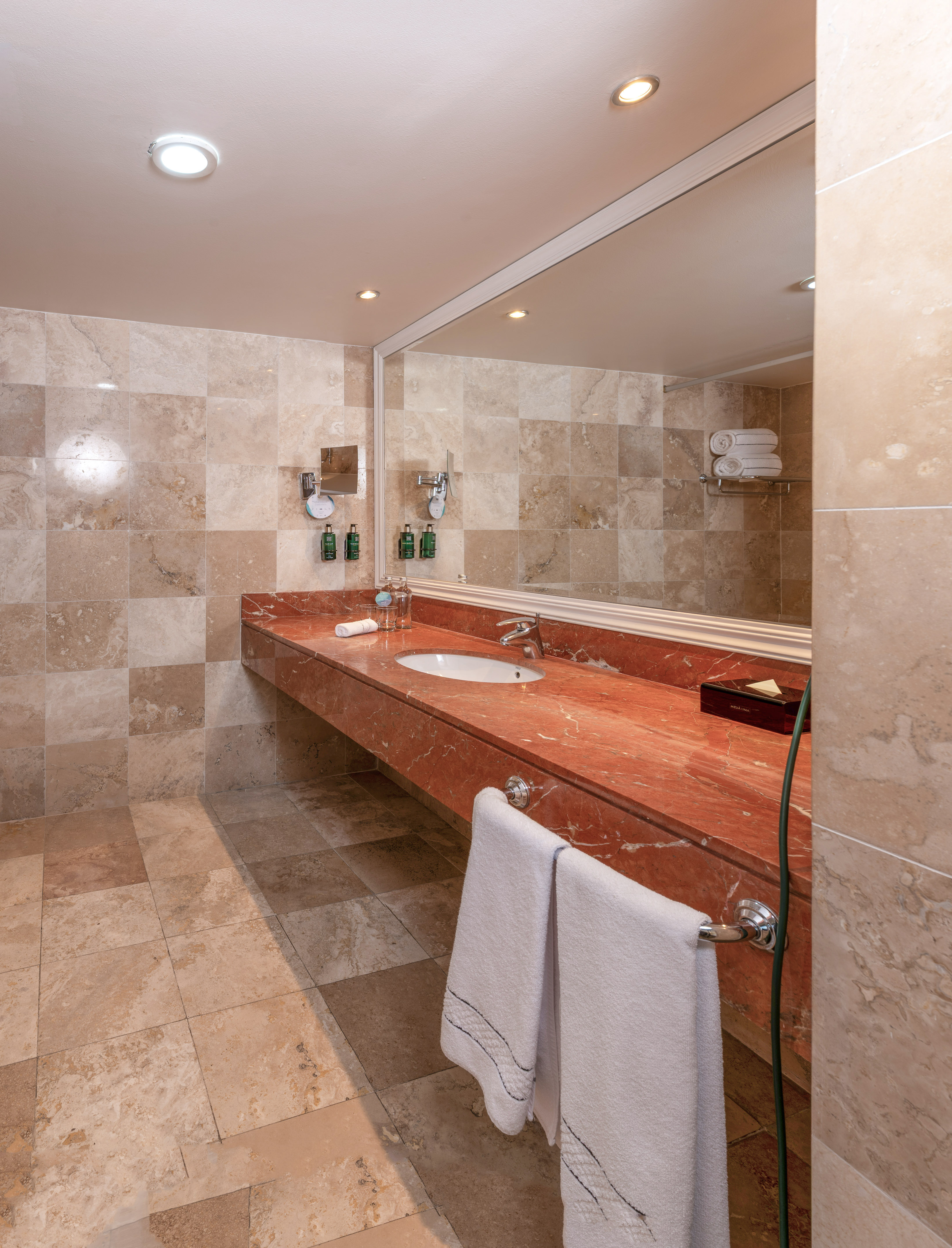 a bathroom with a marble countertop and a mirror
