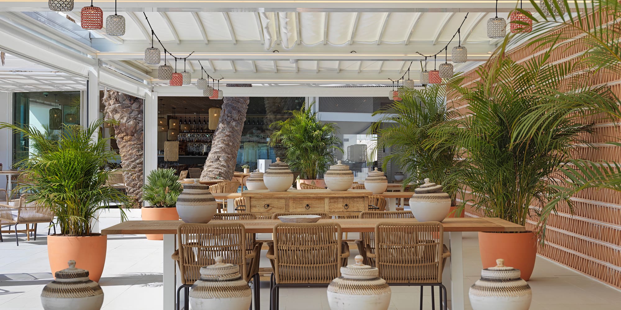 a table with chairs and pots on it