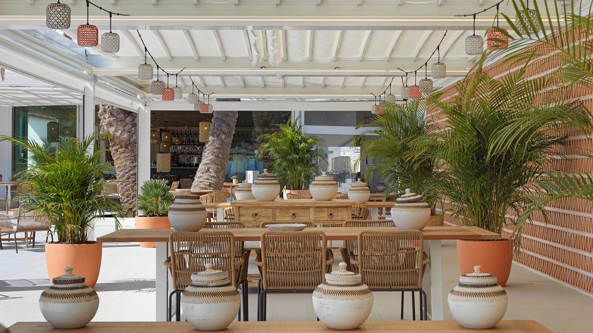 a table with chairs and pots on it