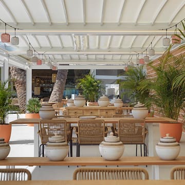 a table with chairs and pots on it