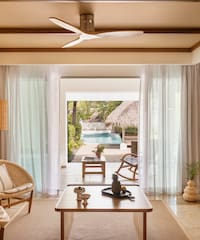 a living room with a table and chairs