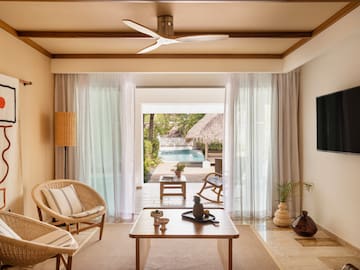 a living room with a table and chairs