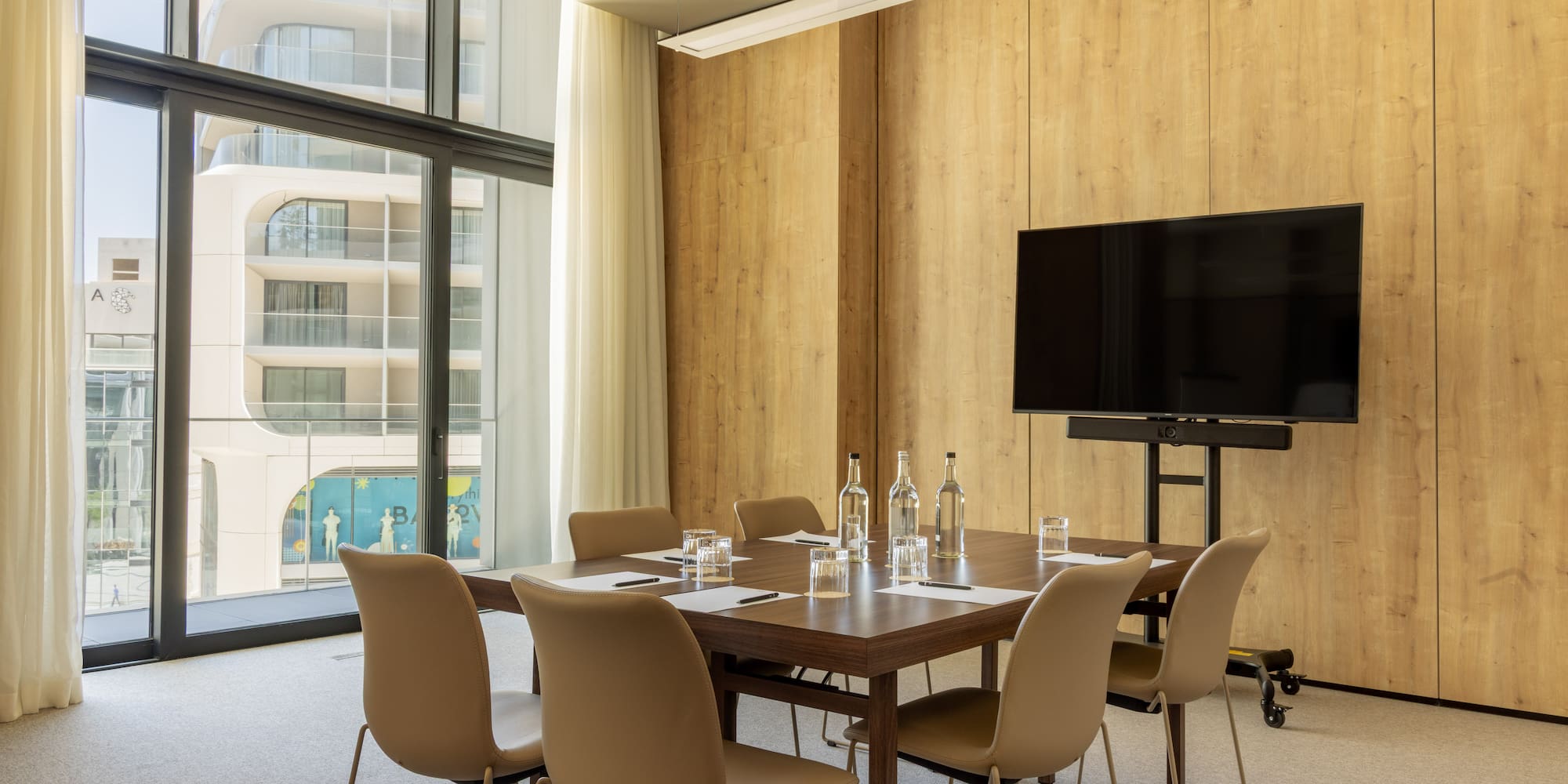 a room with a table and chairs and a television