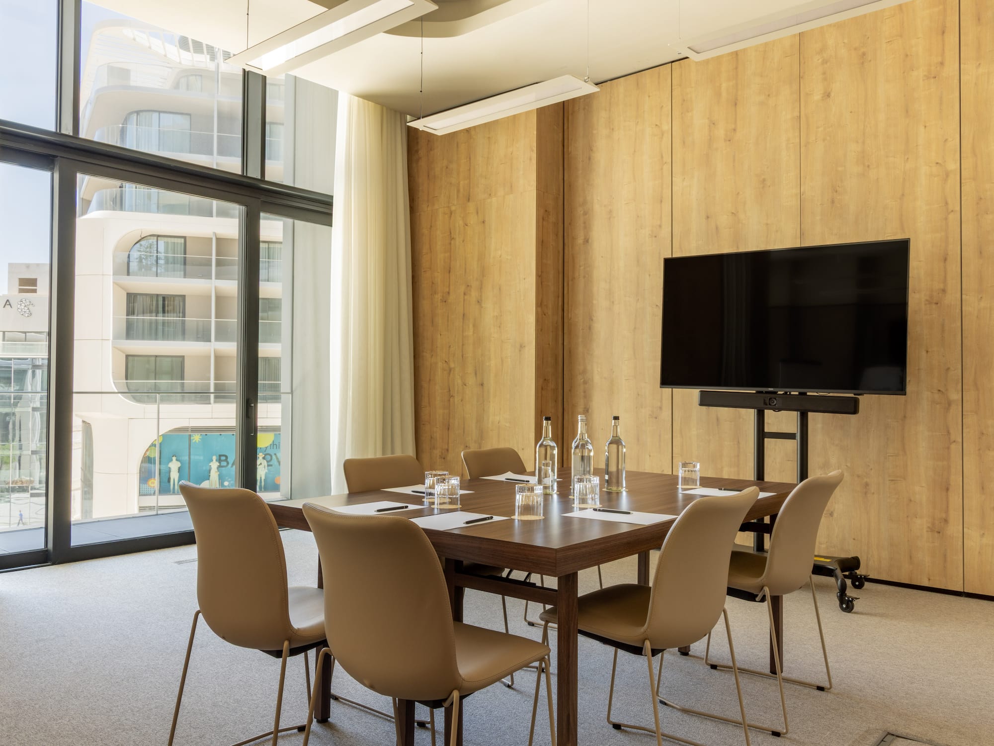 a room with a table and chairs and a television