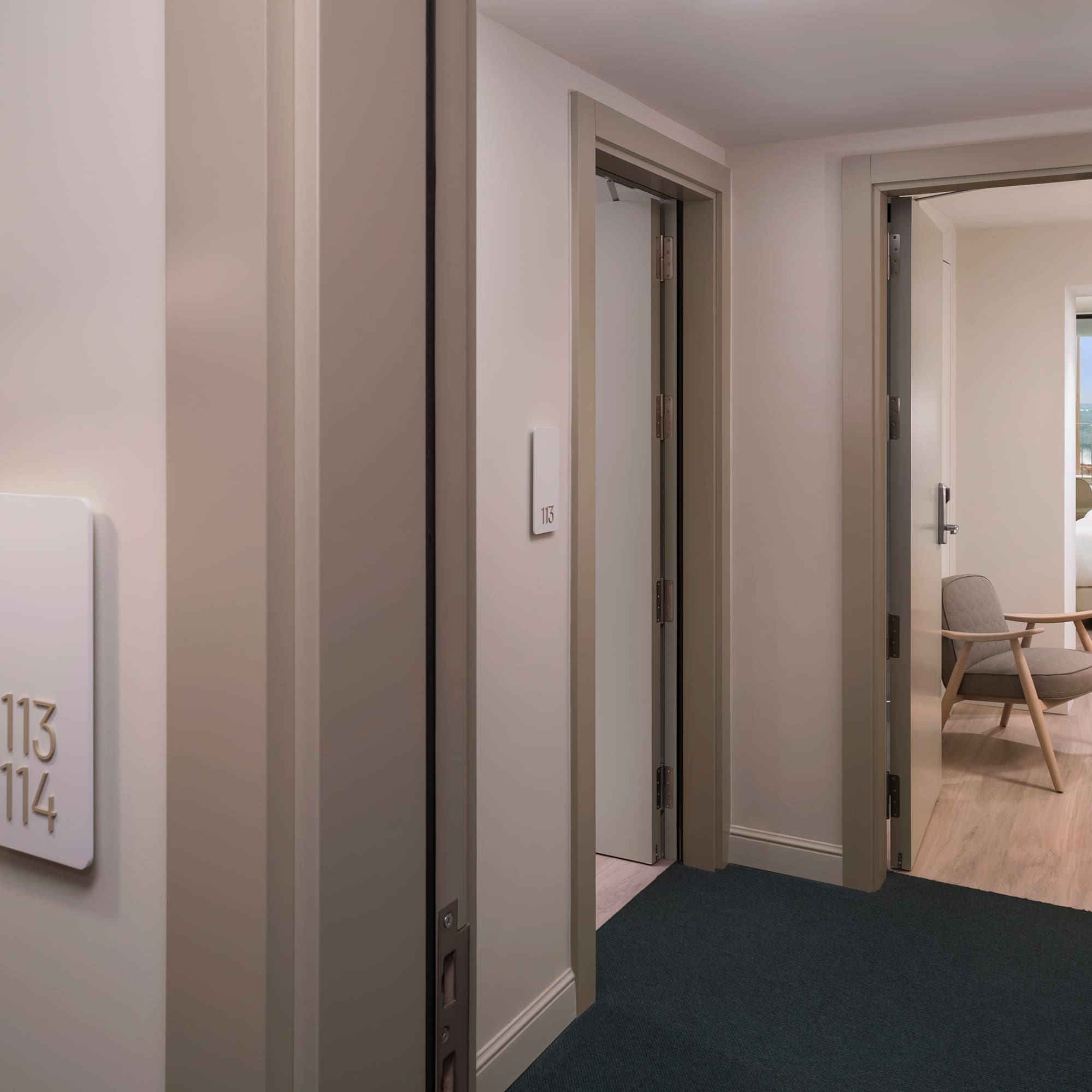 a room with a door and a room with a chair and a table