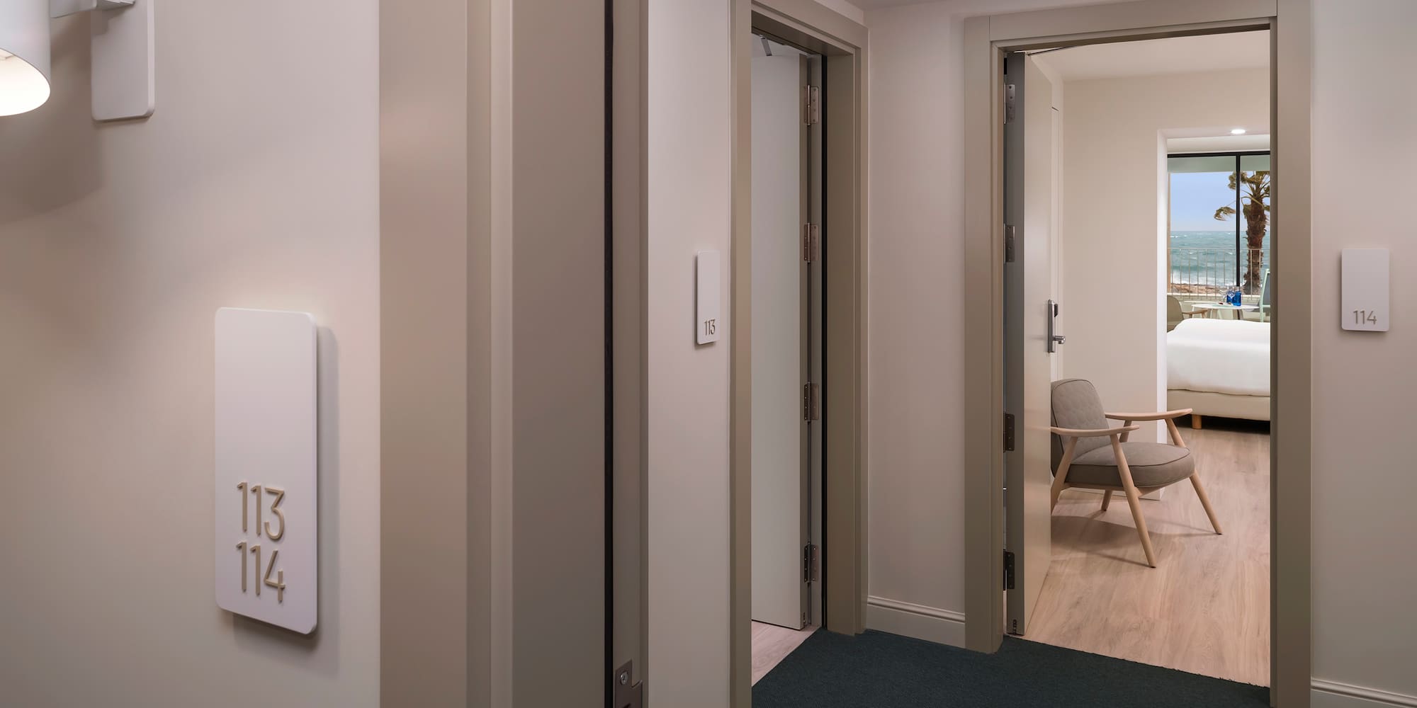 a room with a door and a room with a chair and a table