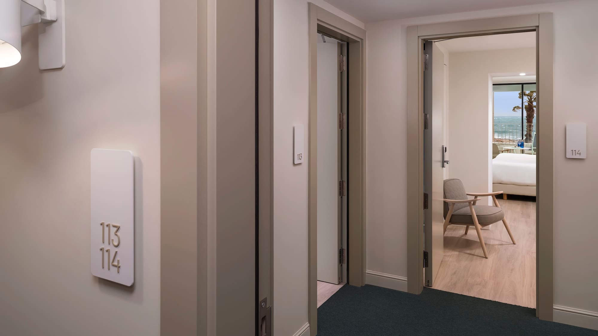 a room with a door and a room with a chair and a table