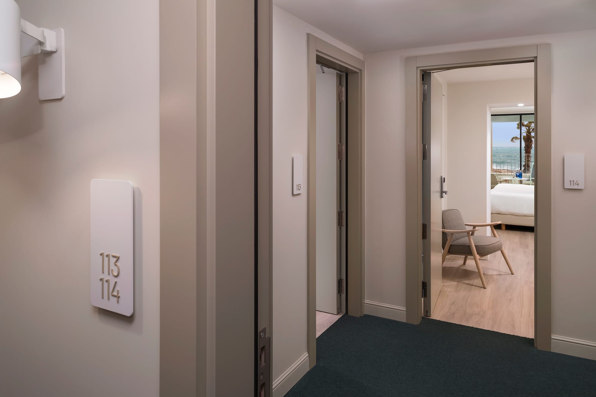 a room with a door and a room with a chair and a table