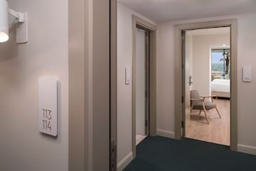 a room with a door and a room with a chair and a table