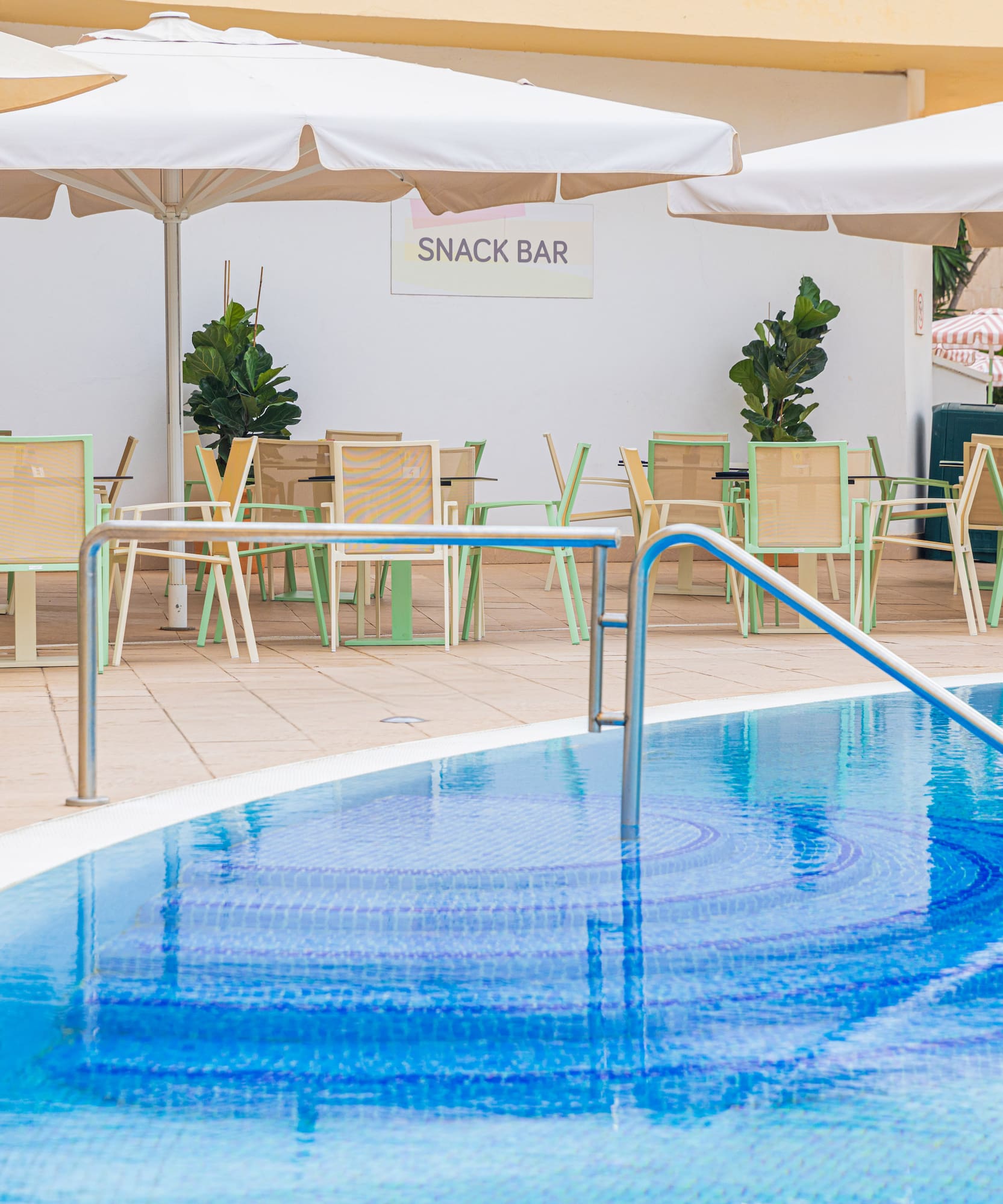 a pool with a bar and chairs