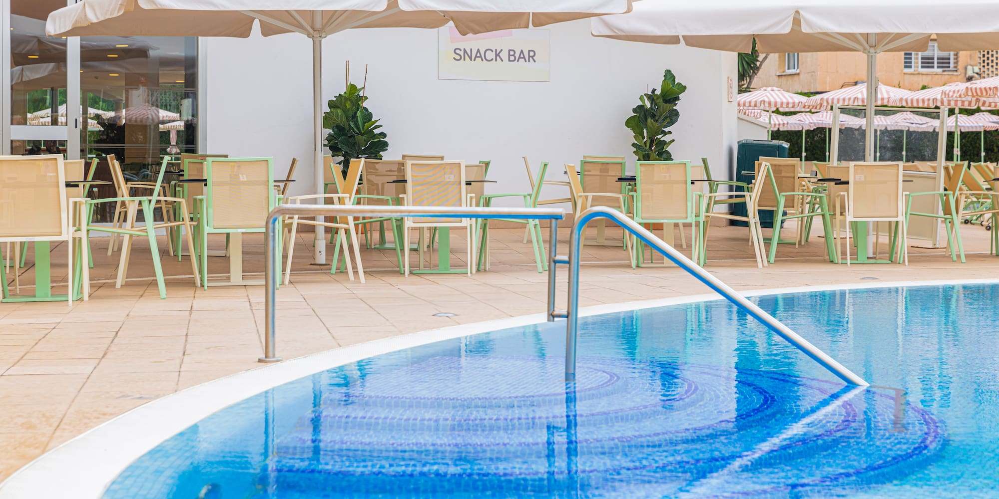 a pool with a bar and chairs