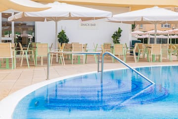 a pool with a bar and chairs