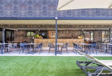 a patio with tables and chairs