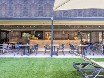 a patio with tables and chairs