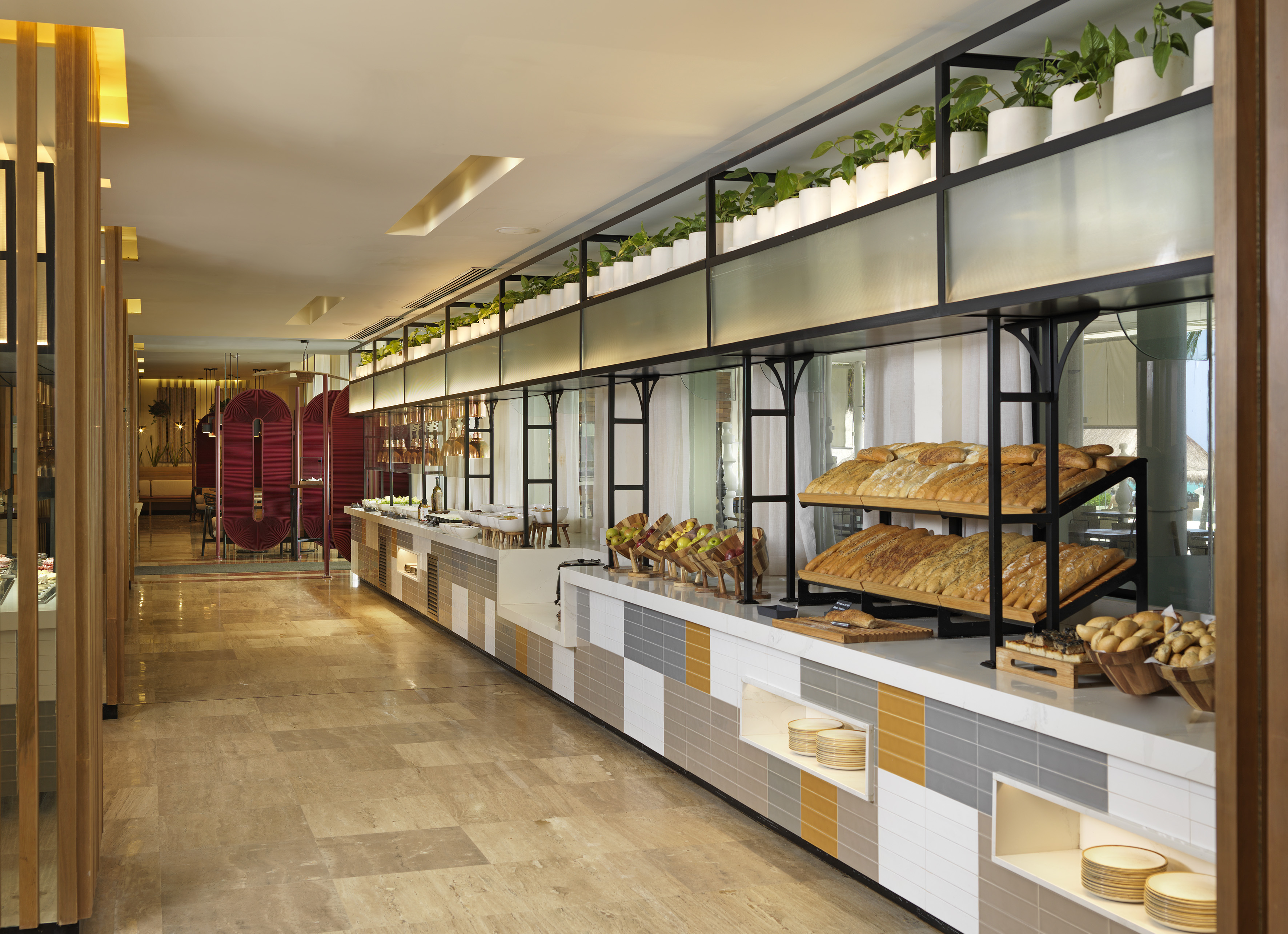 a food buffet with a variety of breads on shelves