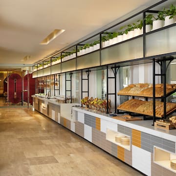 a food buffet with a variety of breads on shelves