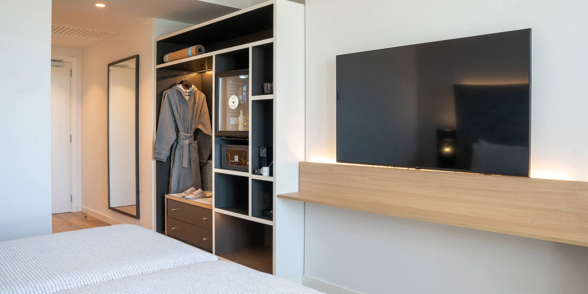 a room with a tv and a mirror