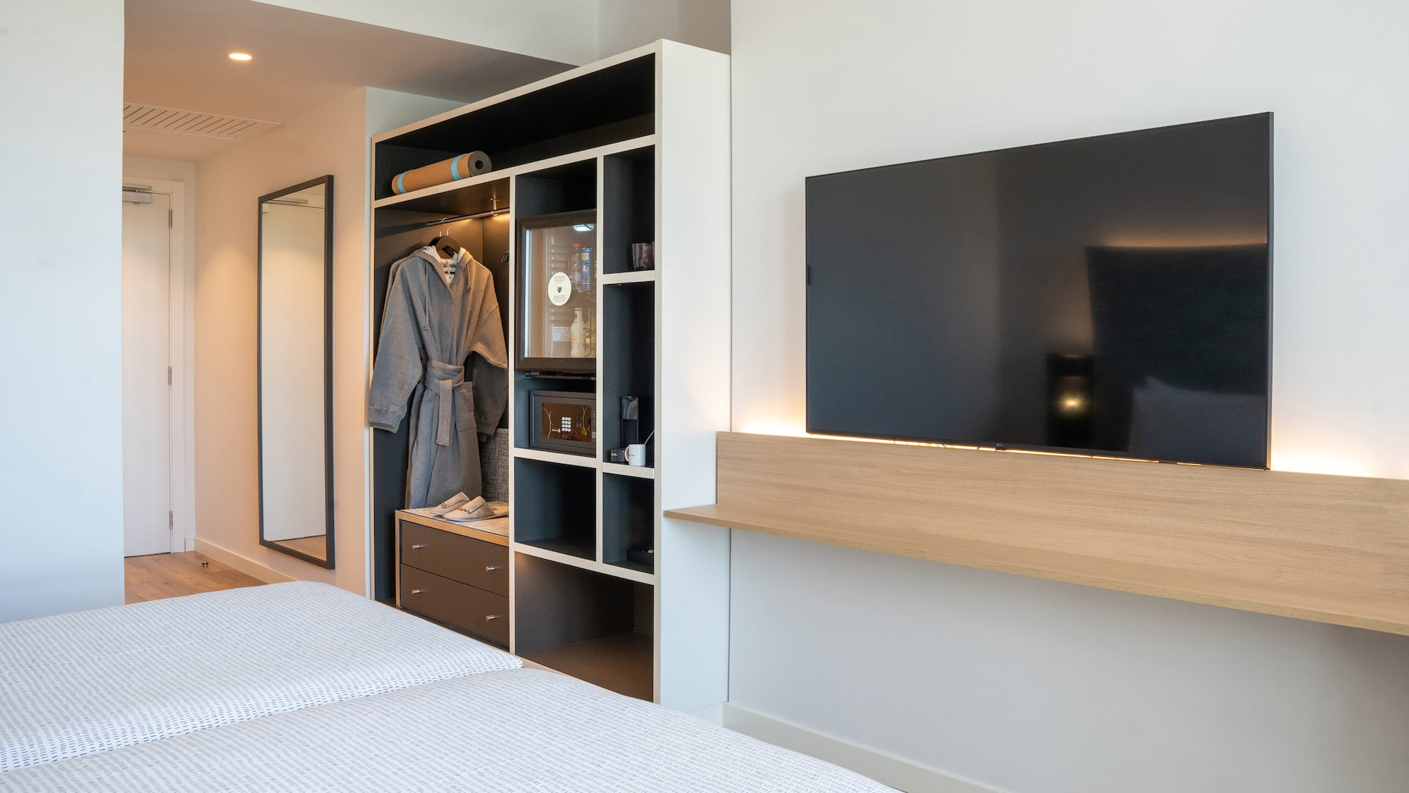 a room with a tv and a mirror