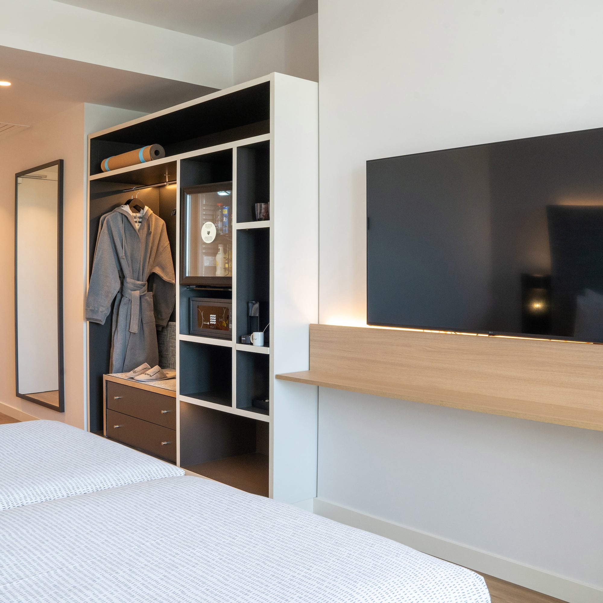 a room with a tv and a mirror