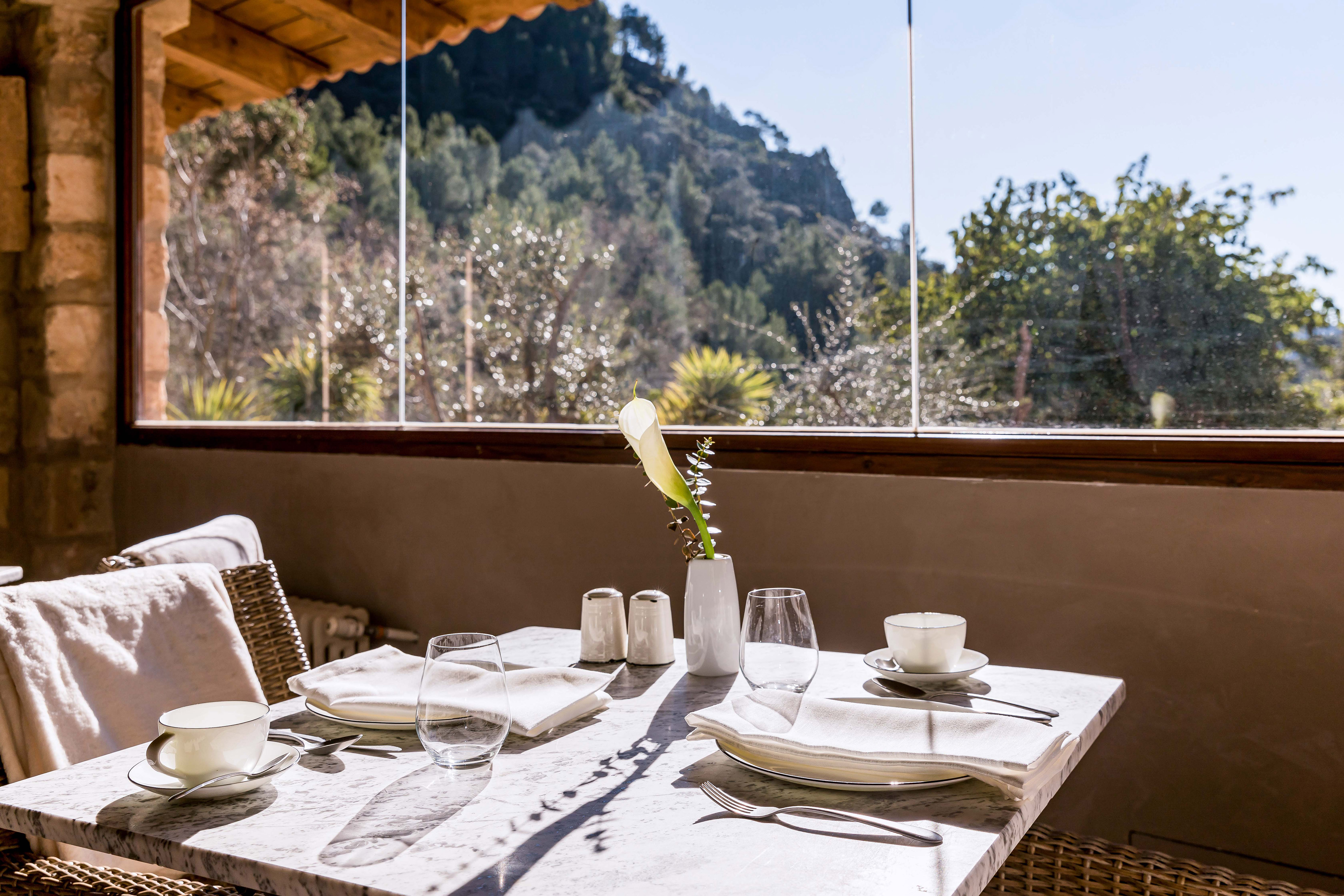 Balcony dining table set for two, scenic mountain view resort.