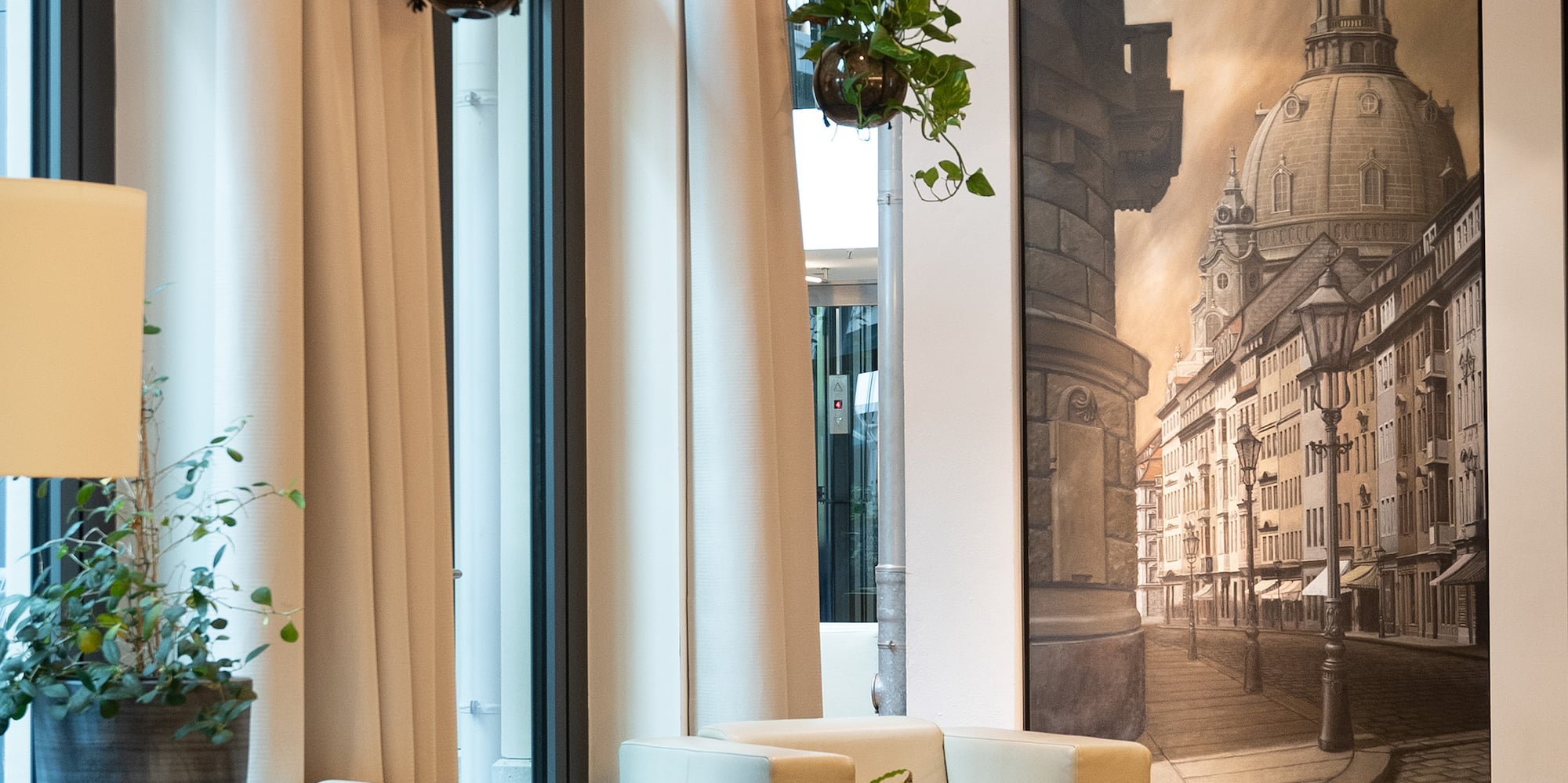 a room with white furniture and a large painting on the wall