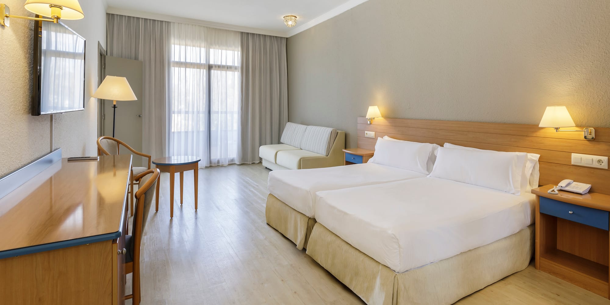 a room with two beds and a table