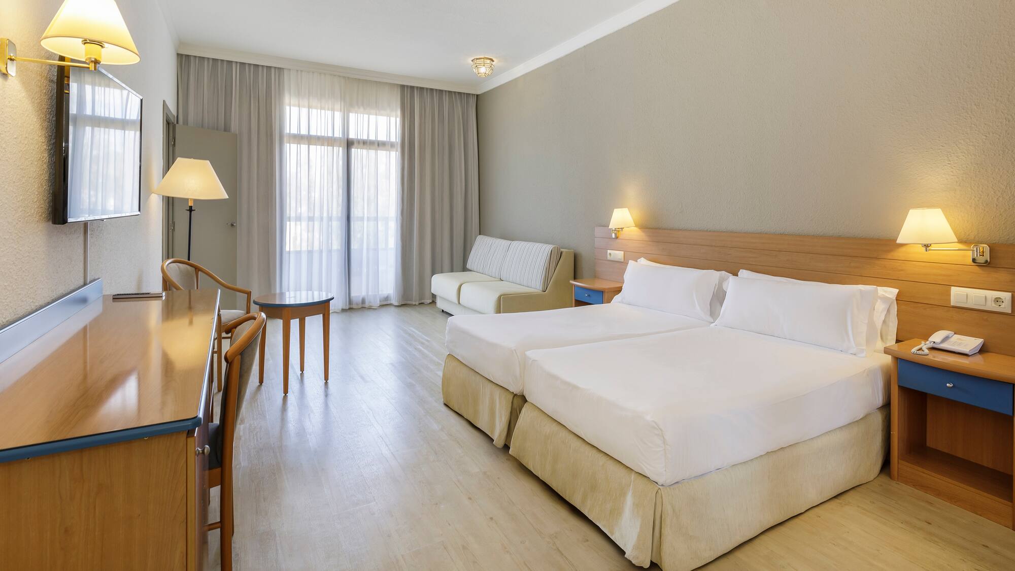 a room with two beds and a table