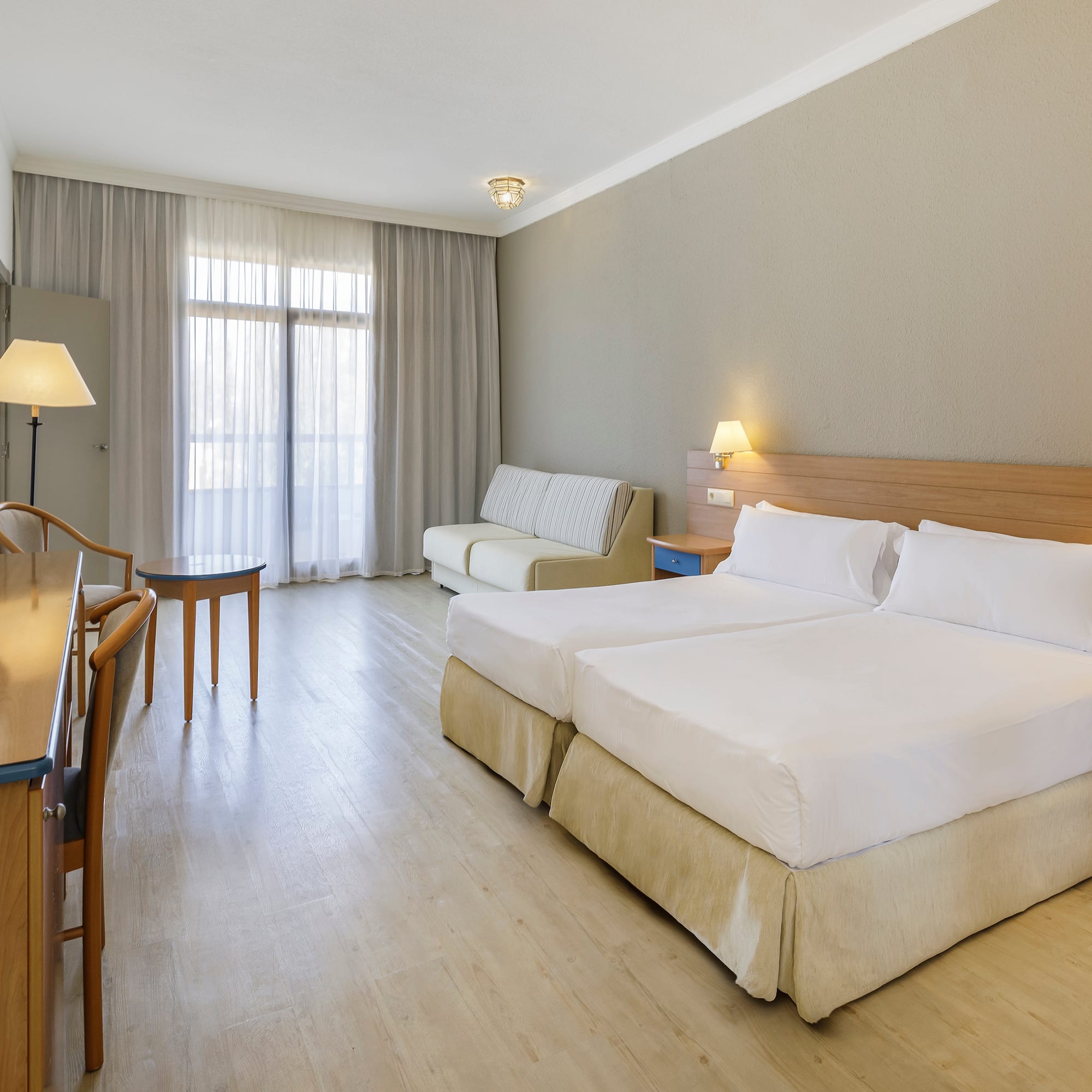 a room with two beds and a table