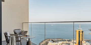 a balcony with a view of the ocean and a city