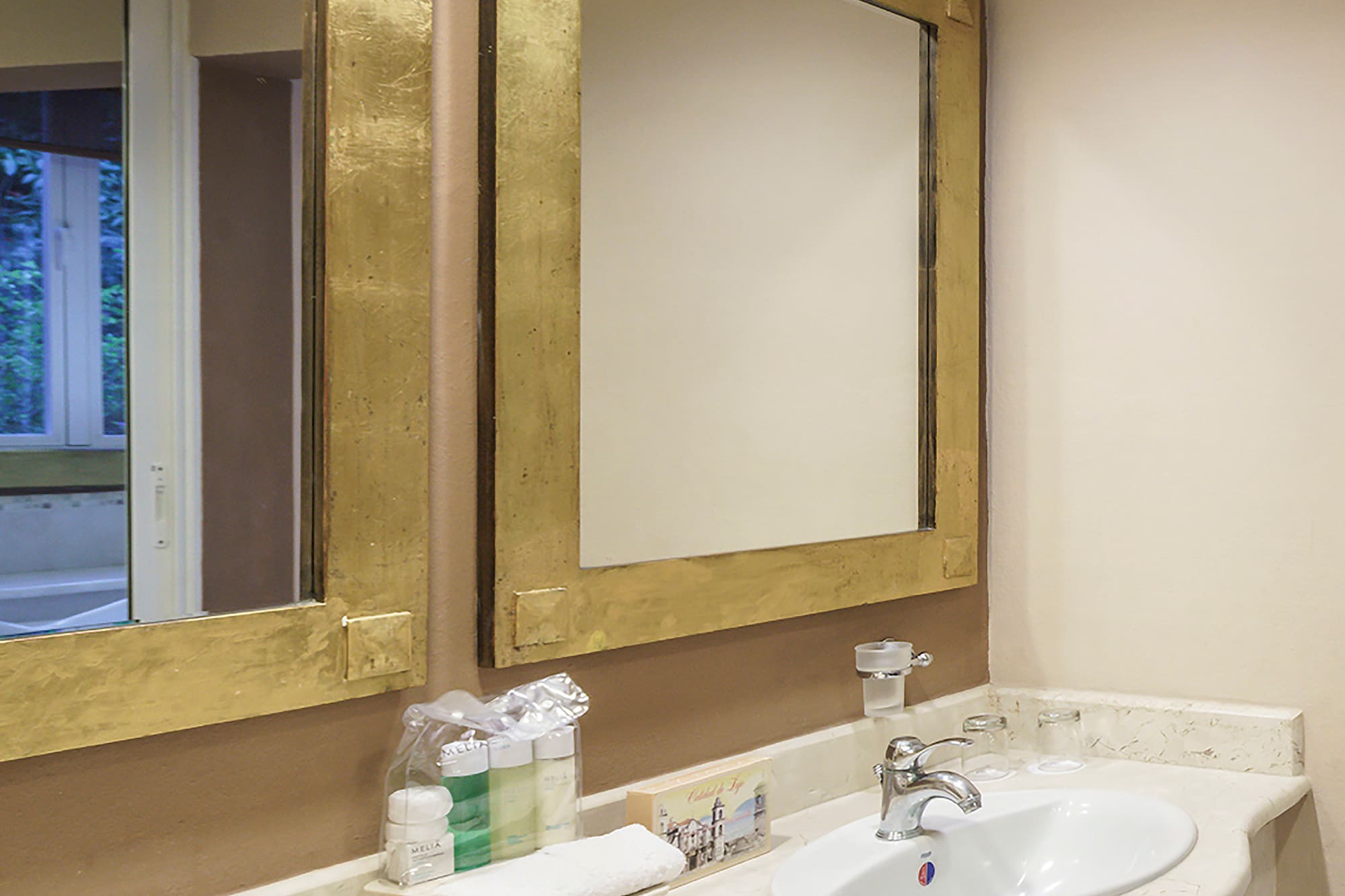 a bathroom with two sinks and mirrors