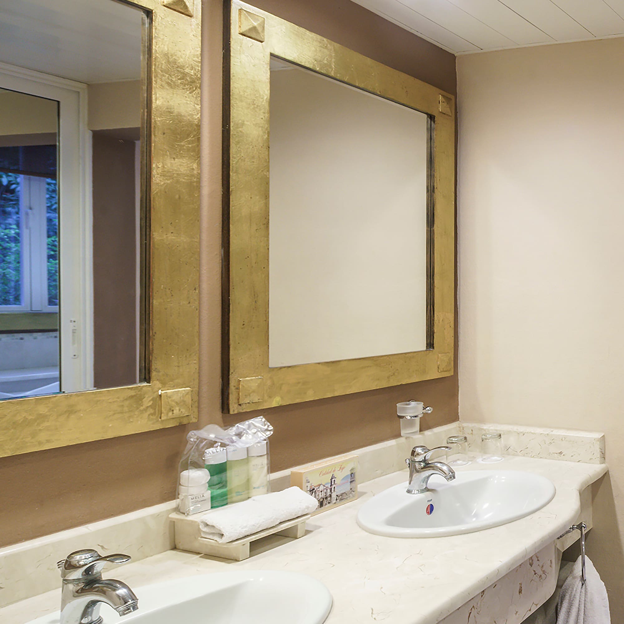 a bathroom with two sinks and mirrors