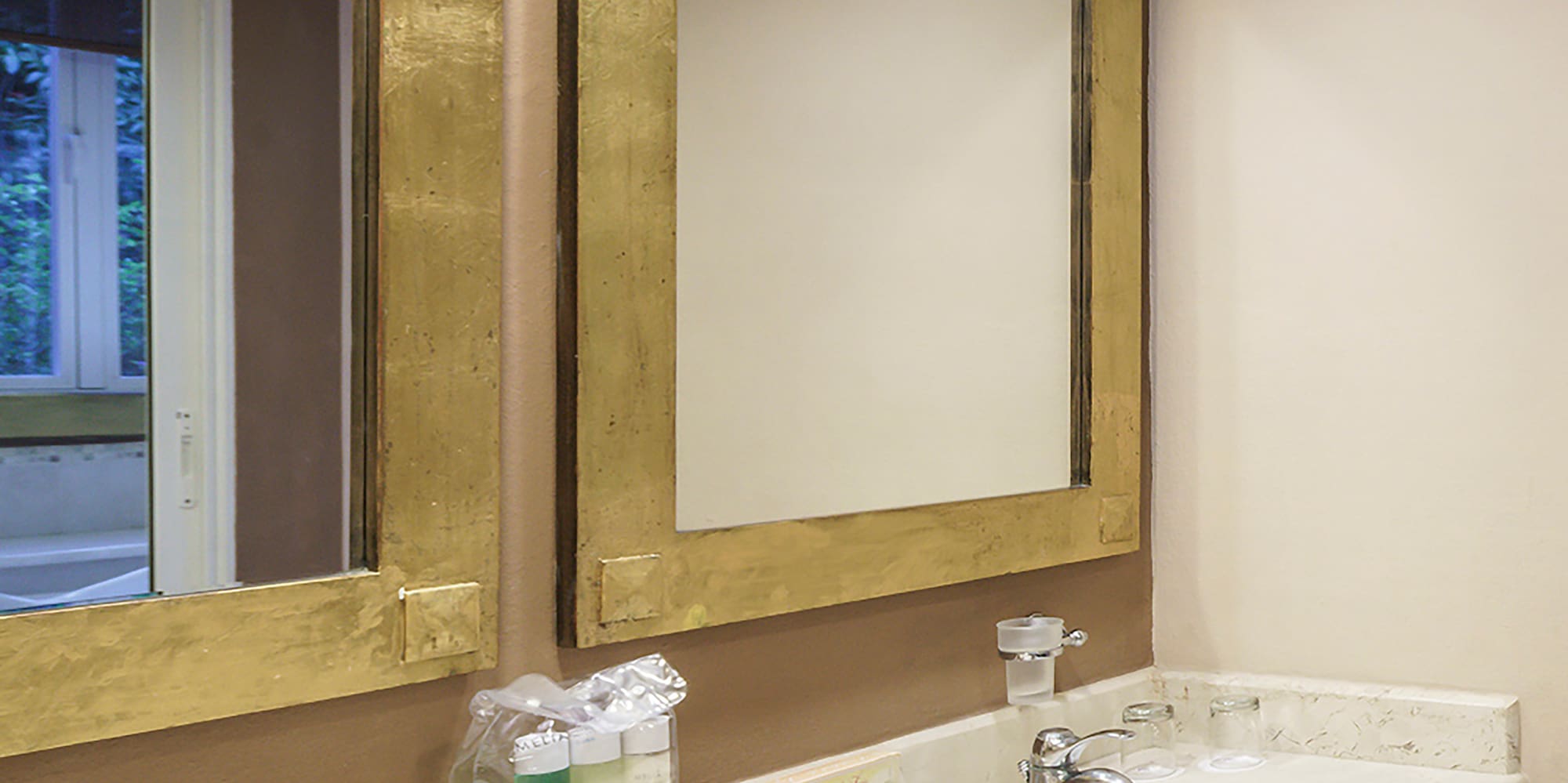 a bathroom with two sinks and mirrors