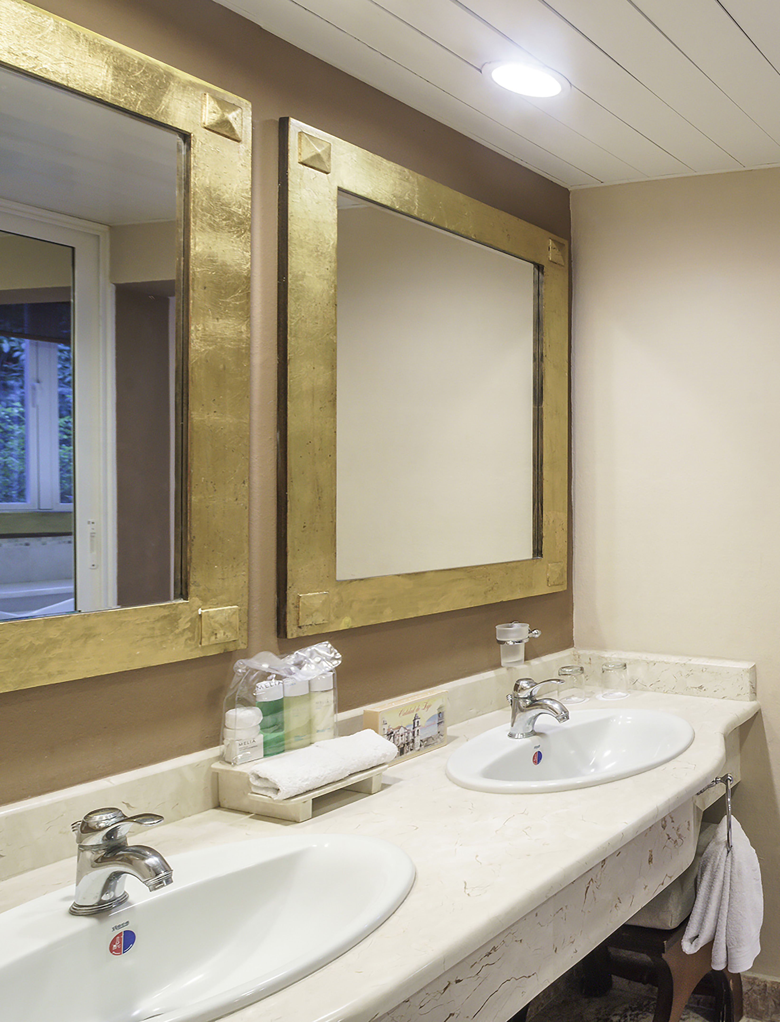 a bathroom with two sinks and mirrors