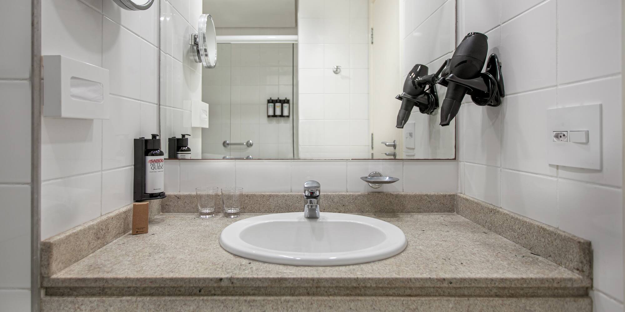 a bathroom sink with a mirror and a mirror